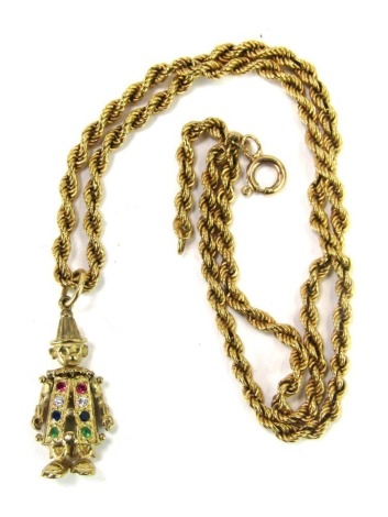 A 9ct gold clown pendant and chain, the clown set with semi precious stones, to include ruby, white stones, emerald and sapphire, stamped 375, 3cm high, on a 9ct gold rope twist neck chain, 40cm long, 16.2g.