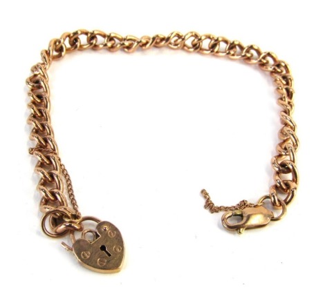 A rose gold curb link bracelet, with heart shaped padlock, clip and safety chain, yellow metal, stamped 9ct, 19cm long, 15.9g all in.