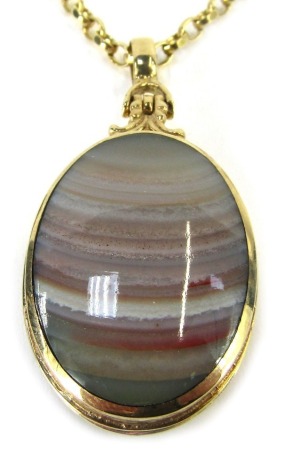 A Victorian semi precious stone set locket and chain, the oval locket set with black agate and striped agate, opening to reveal fitted interior, with bark effect design sides, fully hallmarked 9ct gold, on a curb link neck chain, yellow metal stamped 9ct,