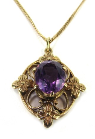 An Elizabeth II 9ct gold pendant and chain, with an oval cut amethyst, in a crown shaped claw setting, in a rhomboid open work and embossed floral design, 3cm high, 1cm wide, on a later 9ct gold fine link neck chain, 60cm long, 7.1g all in.