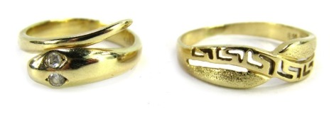 Two dress rings, comprising a snake dress ring set with two tiny diamonds as eyes, size J 1/2, stamped 585, and an Eastern inspired crossover ring, yellow metal stamped 585, size P 1/2, 4.7g all in. (2)