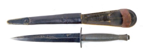 A Fairbairn-Sykes commando fighting knife, blade 18cm long, in leather sheaf.