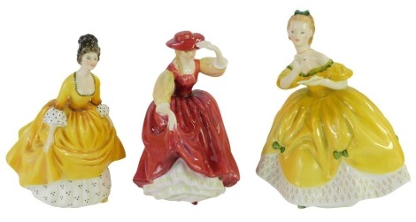 Three Royal Doulton porcelain figures, modelled as The Last Waltz HN2315, Coralie HN2307, Buttercup HN2399, one boxed.