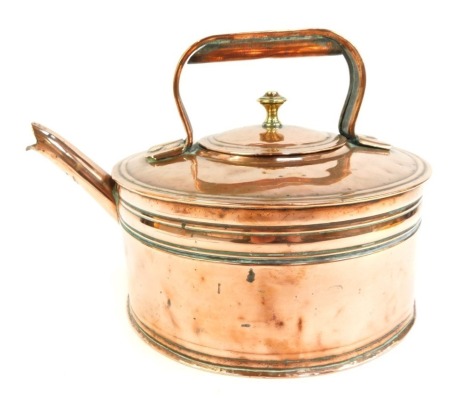 A Victorian copper kettle, of compressed cylindrical form with banded decoration, ring handle and brass handle, 23cm high.