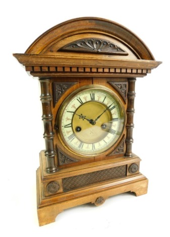 A late 19thC/early 20thC German HAC 14 day strike oak cased mantel clock, the brass circular dial with cream enamelled chapter ring bearing Roman numerals, eight day movement, the case with carved decoration, 36cm high, with key and pendulum.