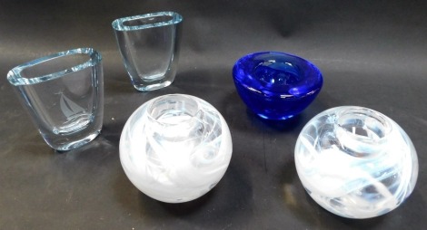 A pair of Kosta Boda glass tea light holders, of globular form with recess for tea light, decorated with abstract swirls in white, 10cm high, together with a blue glass dish, and a pair of Strombergshyttan vases, of oval tapering form, one with etched dec