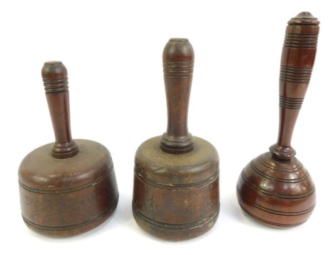 Two early 19thC mahogany mason's mauls , 20cm high, 18cm high, together with a Victorian mahogany gavel, with turned handle with banding, and circular tapering base, 22cm high. (3)