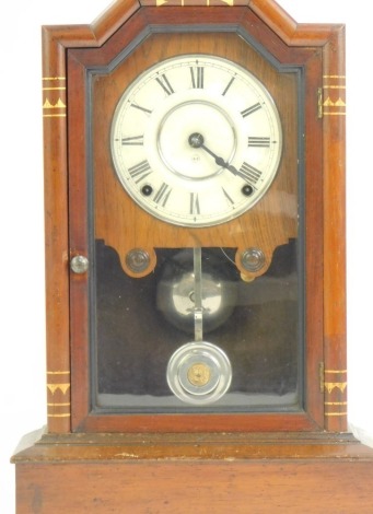 An early 20thC mahogany cased American mantel clock, the white enamel dial bearing Roman numerals, eight day movement, the case with gilt highlights, 52cm high.