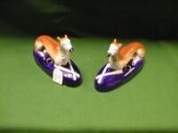 A pair of Staffordshire recumbent greyhound Pen Holders