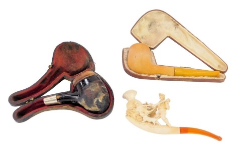 Three pipes, comprising a 19thC meerschaum and amber pipe depicting gentlemen hunting, 13cm wide, a cased pipe and a Vienna meerschaum cased pipe. (3, AF)