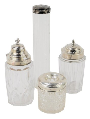 Three silver topped and cut glass dressing table bottles, comprising hat pin cellar, 6cm high, cylindrical cellar, 17cm high, silver topper shaker, 11cm high, and a silver topped mustard, 13cm high. (4)