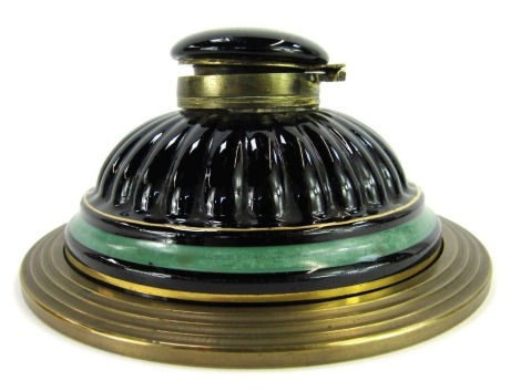 A 19thC stoneware inkstand, black glaze with green banding and gilt highlights, of cylindrical fluted form, on a circular brass base, 13.5cm diameter.