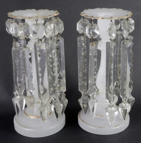 A pair of late 19thC Victorian milk glass lustres, each on a white ground with gilded decoration and petalated top on circular foot, with faceted glass drops, 22cm high. (AF)