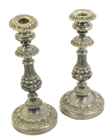 A pair of late Victorian silver plated candlesticks, profusely embossed with flowers, leaves, etc., 27.5cm high.