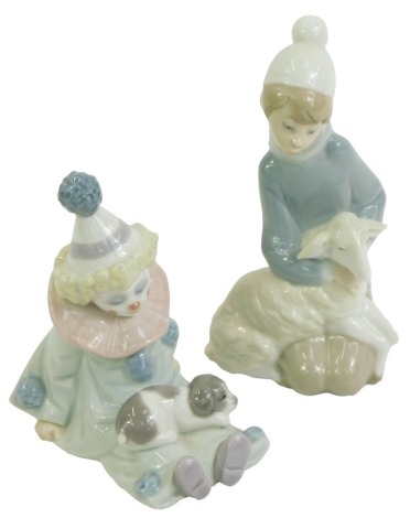 Two Lladro porcelain figures, modelled as a seated clown with a puppy on knee, 13cm high, and boy kneeling holding a lamp, 15cm high.