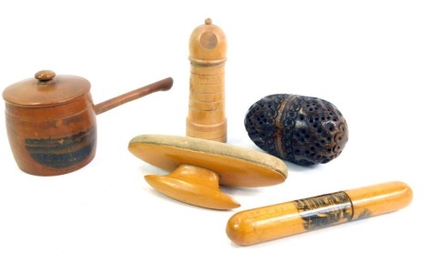 A group of treen, comprising an Alnmouth pan, a Mauchline ware Lincoln Stonebow needle case, a boxwood lighthouse needle case, manicure buffer, and a pierced storage egg. (5)