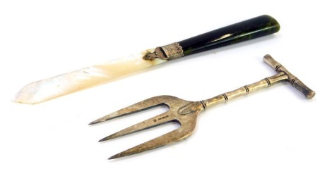 Two 20thC white metal trinkets, comprising a silver plated meat fork, and a mother of pearl green agate and silver collar letter opener. (2)