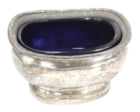 A George V silver salt, of fluted design, with a gadrooned rim, and blue glass liner, Birmingham 1930, 1.61oz.