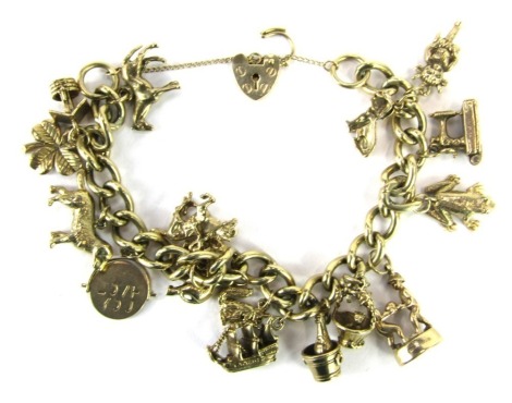 A 9ct gold charm bracelet, with fifteen various charms, safety chain and padlock clasp, 62.6g all in.