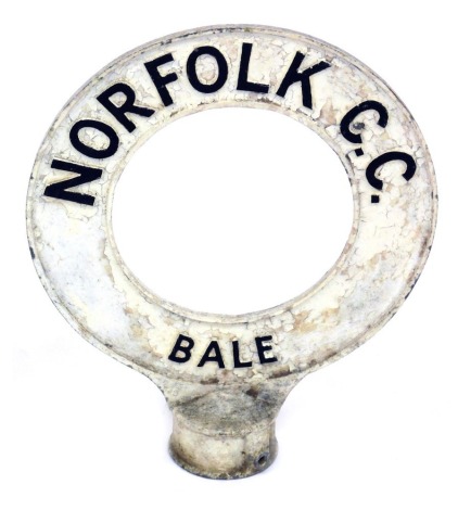 An early 20thC Norfolk CC road sign, for Bale, with a circular loop design on a circular fitting, 39cm high.