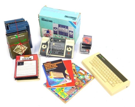 A group of Acorn Soft cassettes, Acorn computer procedure manual, an Amstrad Grandstand and an Amstrad keyboard. (a quantity) WARNING! This lot contains untested or unsafe electrical items. It is supplied for scrap or re-conditioning only. TRADE ONLY