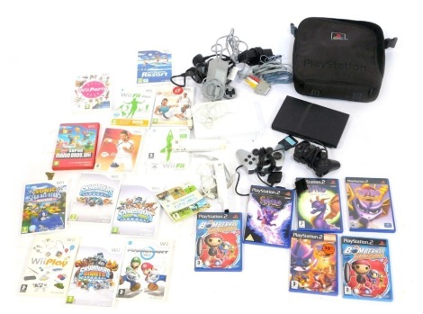 A Wii games console and various accessories, handles, nunchucks, two replica Playstation controllers, Wii games to include EA Sport Active, Wii Fit and others, Playstation 2 games to include Spyro, Legends of Spyro etc. (1 box)