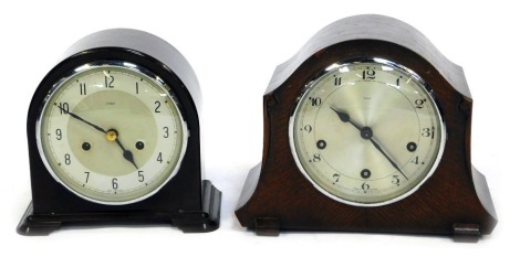 Two Enfield mantel clocks, comprising a brown Bakelite cased mantel clock, with domed top, on bracket feet, 21cm high, 18cm wide, and an oak cased example with silvered numeric dial, 22cm high, 26cm wide. (2)