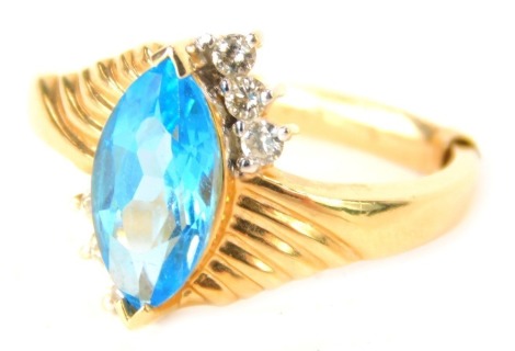 A dress ring, the central shaped marquise turquoise blue stone in crossover setting set with tiny diamonds, with ring sizer, yellow metal stamped 14kt, ring size O½, 5.8g all in.