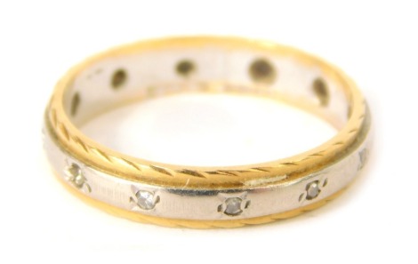 An eternity ring, partially set with white stones, some missing, with gold coloured outer border and white gold centre, unmarked, size N½, 3.2g all in.