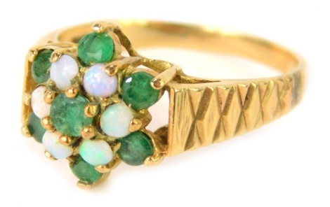 A 9ct gold floral cluster dress ring, set with an opal and emerald, with cross hatched shoulders, with rubbed hallmarks, size P, 3.1g all in.