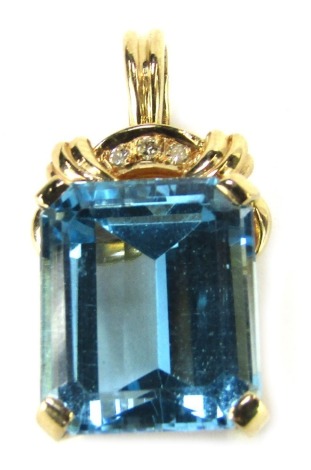 A pendant, set with rectangular cut pale blue stone, rectangular cut, 13.2mm x 11.4mm x 7.2mm, the arched top set with three tiny diamonds, in yellow metal stamped 14k, 2.5cm high, 6.8g all in.