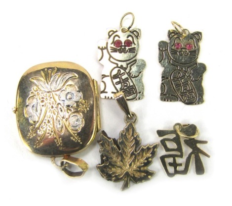 Five yellow metal pendants, comprising a 9ct gold floral bicolour locket, two yellow metal Chinese cat pendants set with garnet set eyes, Chinese writing pendant, unmarked, and a 9ct gold maple leaf, 4.1g all in.