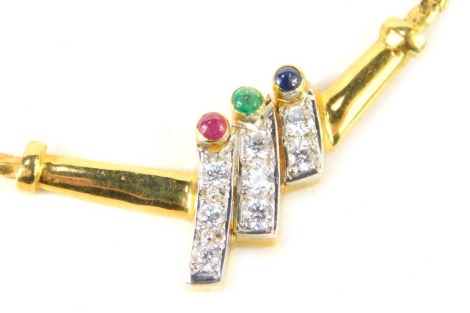 A semi precious stone set Middle Eastern style necklace, the pendant cluster with three bars sets with cabochon ruby, emerald and sapphire, and three tiers with three round brilliant cut diamonds and two round brilliant cut diamonds, 4cm wide, on a yellow