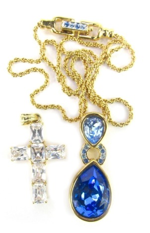 A Swarovski crystal pendant, with a layered blue crystal, on gold finish chain, the pendant 4cm high, and unmarked crucifix set with white crystal, 3.5cm high. (2)