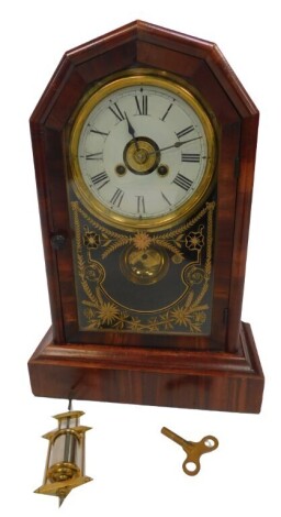 A late 19thC American rosewood cased alarm mantel clock, circular brass dial with chapter ring bearing Roman numerals, eight day movement with bell strike, the case of arched form, with glass front, gilt highlighted with flowers, on a plinth base, with me