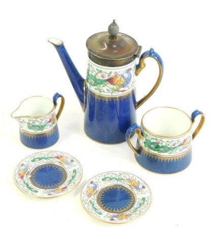 A Wedgwood Peacock pattern part coffee service, decorated with a band of peacocks above a powder blue ground, gilt heightened, W121, printed and painted marks, comprising coffee pot, milk jug, sugar bowl and two saucers, the coffee pot, 16cm high.