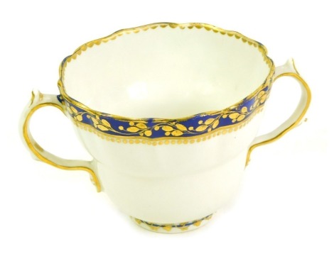 A late 18thC Derby twin ecuelle, of fluted ogee form, decorated in cobalt blue and gilt, with a bands of repeating leaves, painted puce, 8cm high.