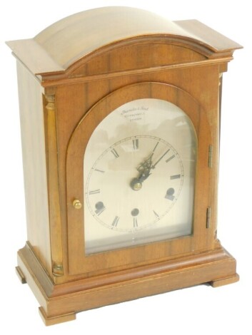 A Thwaites and Reeds of Clerkenwell mahogany cased mantel clock, the silvered arched dial with chapter ring bearing Roman numerals, eight day movement with Westminster chimes, the case of pedimented architectural form, raised on bracket feet, 31cm high, 