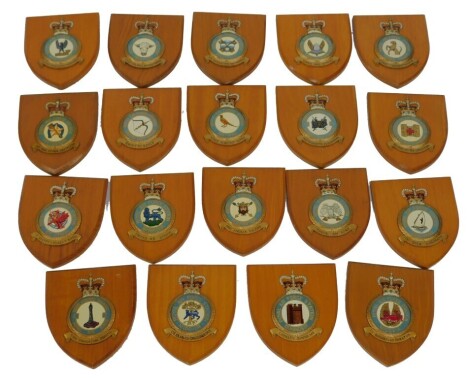 A group of Royal Air Force station plaques, to include Ballykelly, Bottisham, Binbrook, Feltwell, Middle Wallop, Medmenham, St Athan, North Luffenham, Honington, and others, each on a shield back, 18cm high.