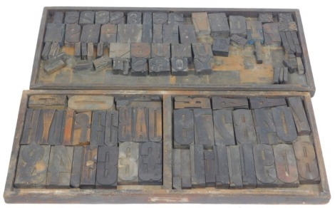 Vintage wooden letter press numbers, letters and punctuation, approx 100 individual printing blocks, in two original printer's trays, 82.5cm x 35cm.