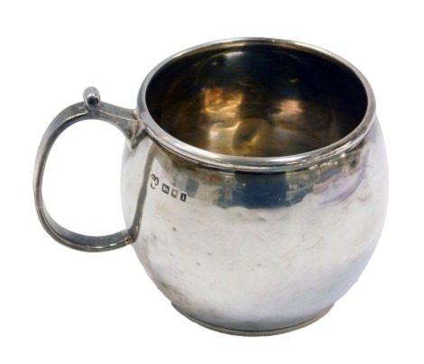 A George V silver christening tankard, with a C scroll handle, engraved Peggy, London 1924, 7cm high, 2.87oz.