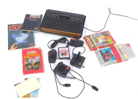 An Atari video computer system, controller, Donkey Kong and Combat, and ET Atari 56 games, and some manuals. (1 box)