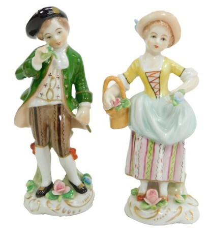 Two Sitzendorf porcelain figures, modelled as a boy with a flower, and a girl with a basket of flowers, printed marks, 11cm high. (2)