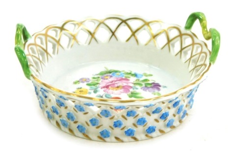 A Dresden porcelain twin handled basket, painted and encrusted with flowers, printed mark, 9.5cm diameter.