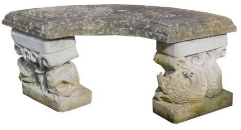 A composition garden bench, the top of fan form raised on two dolphin carved supports, 44cm high, 107cm wide.