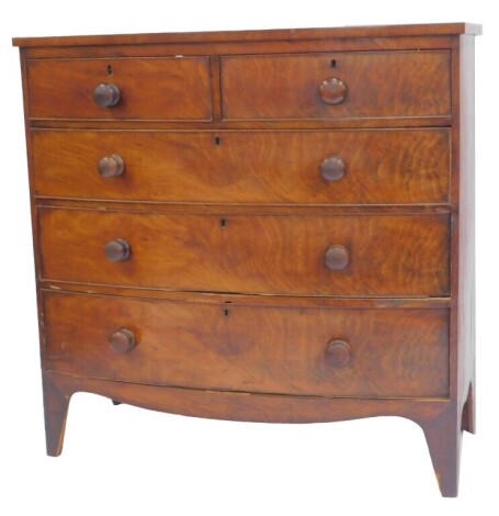 A Victorian mahogany and flame mahogany bow front chest, of two short and three long drawers, on tapering legs, 103cm high, 106cm wide, 53cm deep.