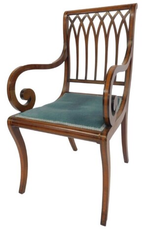 An Edwardian mahogany and inlaid armchair, the pierced back multiple arch form with scrolling arms, blue dralon overstuffed seat, on sabre legs.