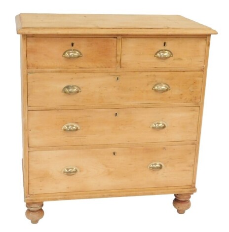 A late Victorian pine chest, the top with a moulded edge above two short and three long drawers, on turned circular feet, 104cm high, 97cm wide, 53cm deep.