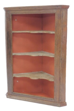 A 19thC oak hanging corner cabinet, the open front enclosing three shaped shelves with a terracotta painted back, on moulded base, 104cm high, 76cm wide, 36cm deep.