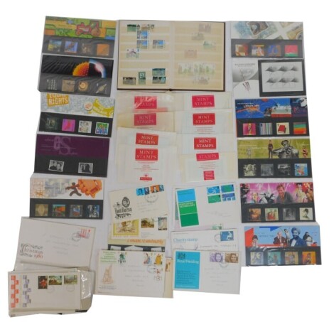 Philately. A collection of first day covers and postage stamps, to include George V and later stamp album, postally worn stamps to include Battle of Britain 4d's, Olympic Games,13p stamps, 1980s and 1990s commemoratives, etc, loose and postally worn stamp